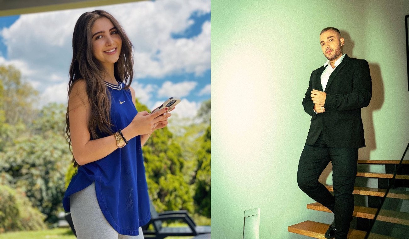 Hombre con vestido elegante y mujer sonriente con celular en mano