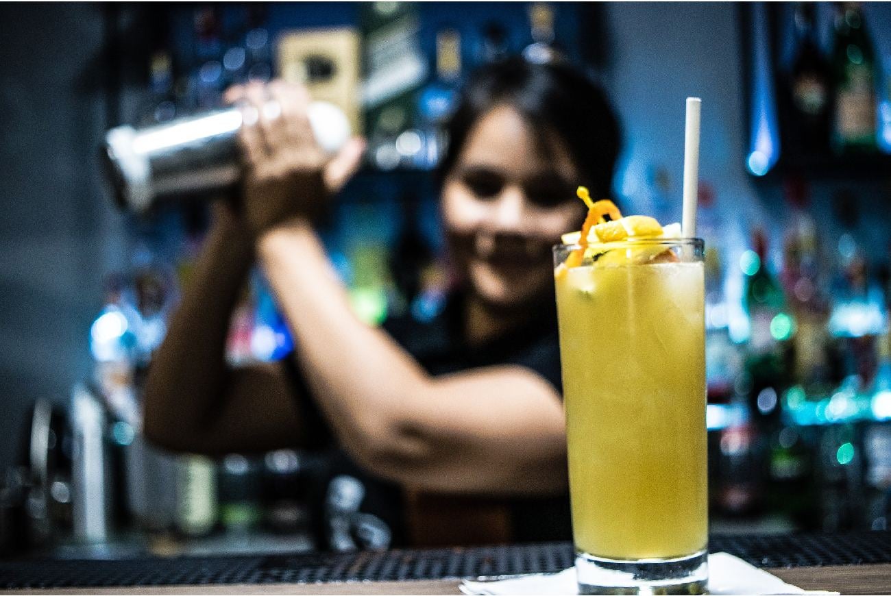 Mujer preparando un coctel