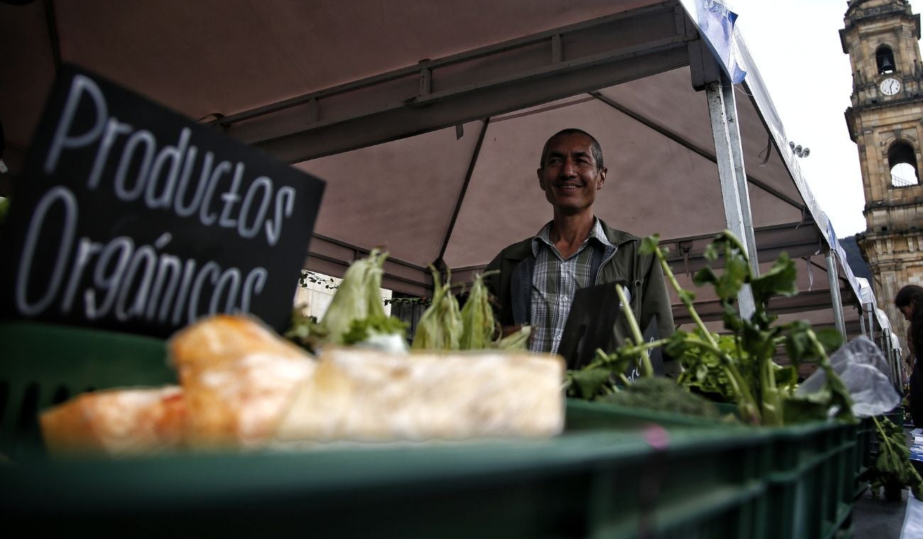 Agricultor ofreciendo sus productos en mercado campesino