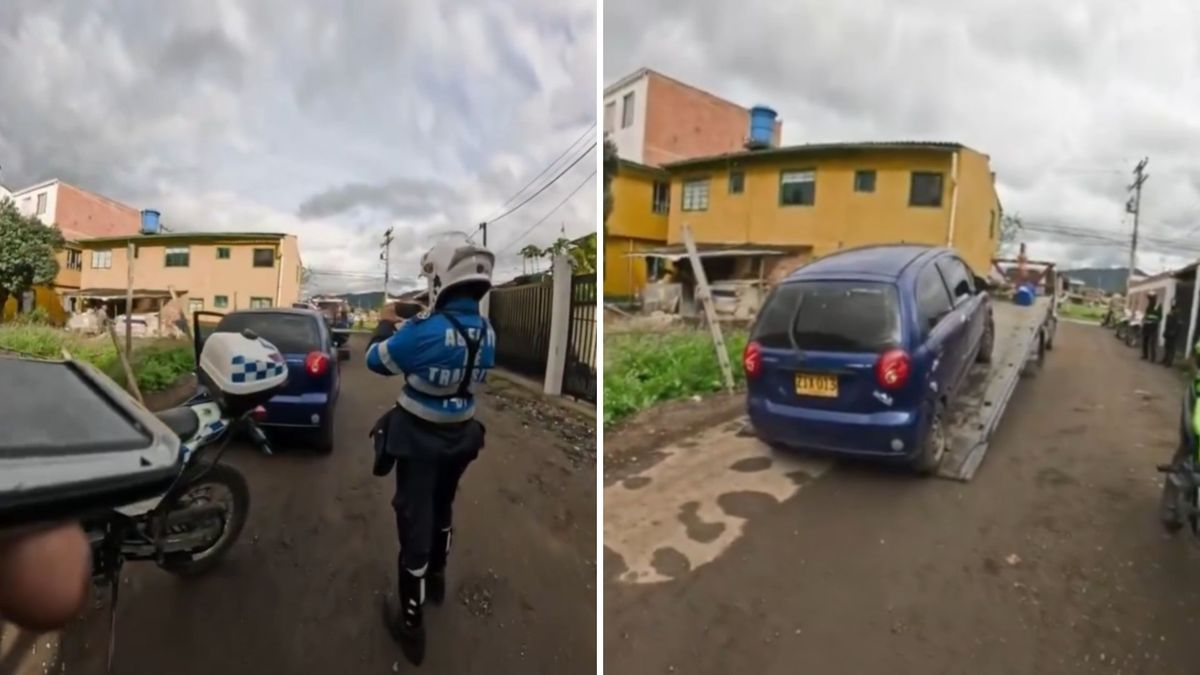 Carro spark azul siendo inmovilizado por agentes de tránsito